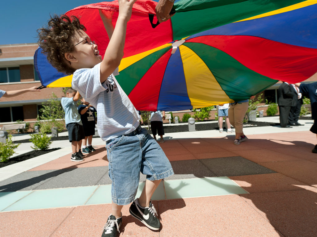 Child playing with giant parachute